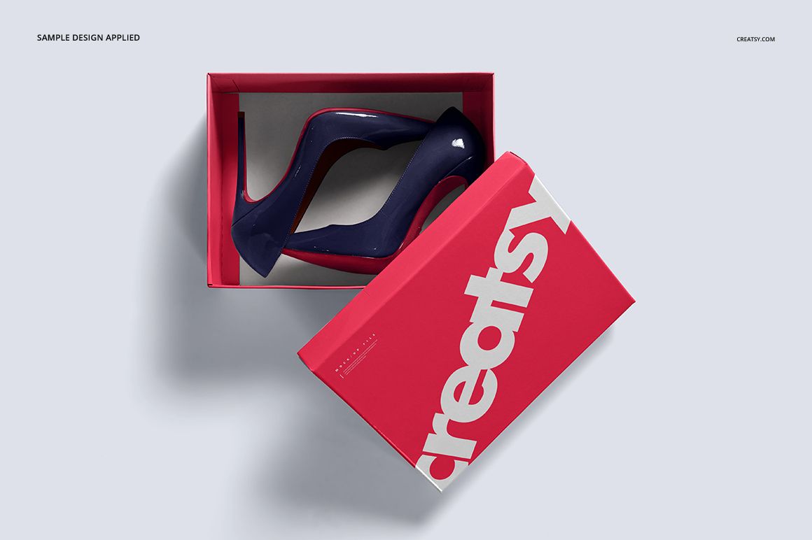 Shoe box mockup featuring a bold pink lid with white lettering, shown from above with high heel shoes inside.