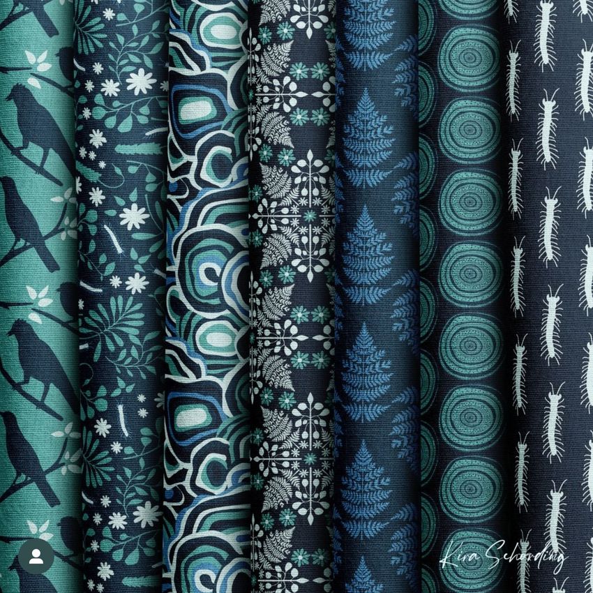 Fabric stack mockup showing seven folded fabrics in vertical rows, each with unique blue and teal patterns and nature-inspired designs.