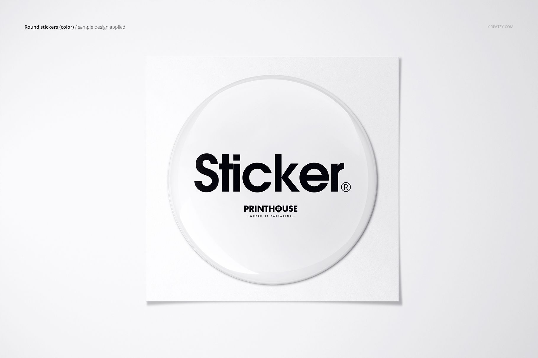 Top view of a circular epoxy dome sticker mockup featuring bold black lettering on a clean white surface.
