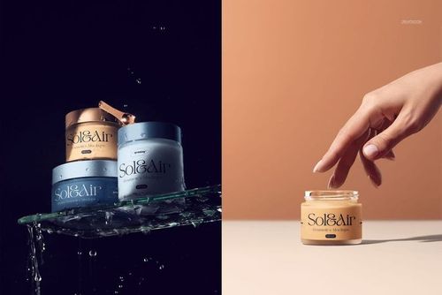 PSD mockup featuring cosmetics packaging jars in blue and gold, water droplets and glass, split scene with hand.