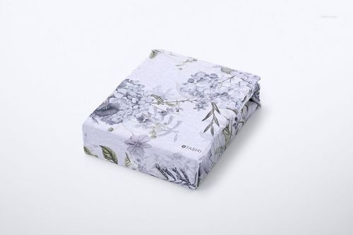 Brushed cotton sheet mockup featuring a folded sheet with subtle botanical design, shown from a front angle.