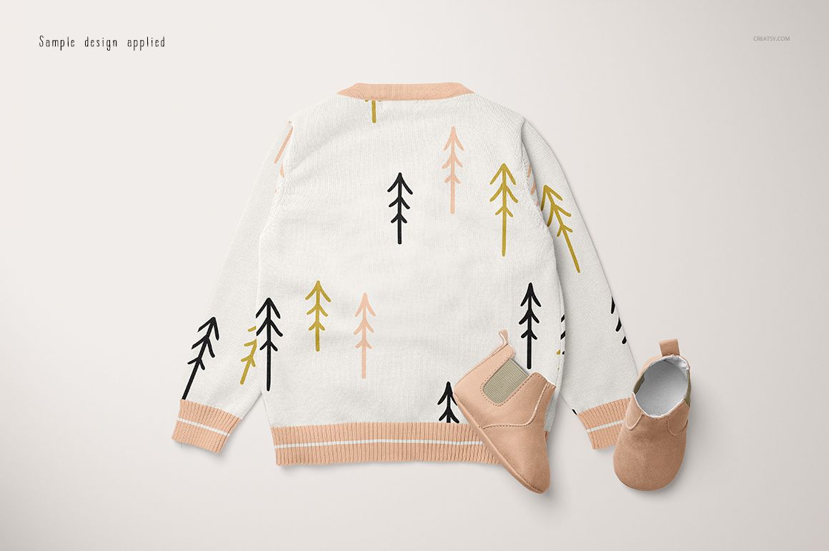 Baby cardigan sweater mockup with a back view, featuring abstract tree patterns in black, yellow, and peach tones.