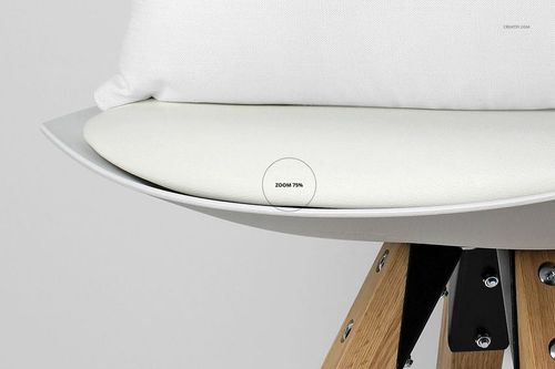 Close-up front view of a white pillow on a modern chair with light wooden legs, shown in a mockup setting.