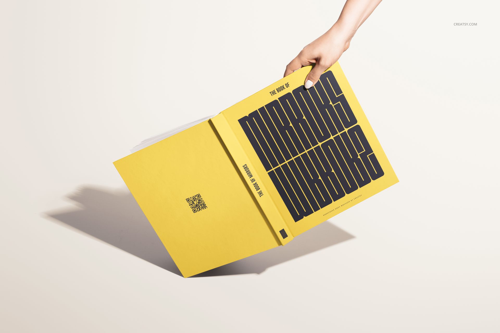 Yellow hardcover book mockup with large black lettering on the cover, displayed at an angle against a light background.