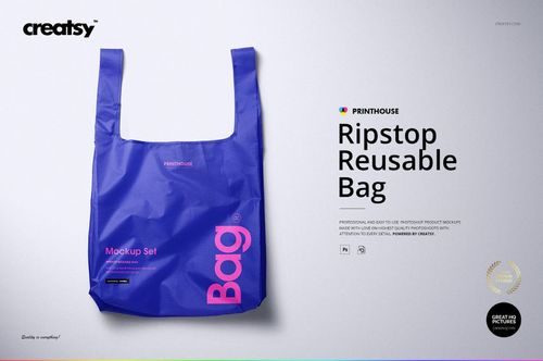 Blue ripstop reusable bag mockup shown from the front, featuring bold pink and white lettering and a simple backdrop.