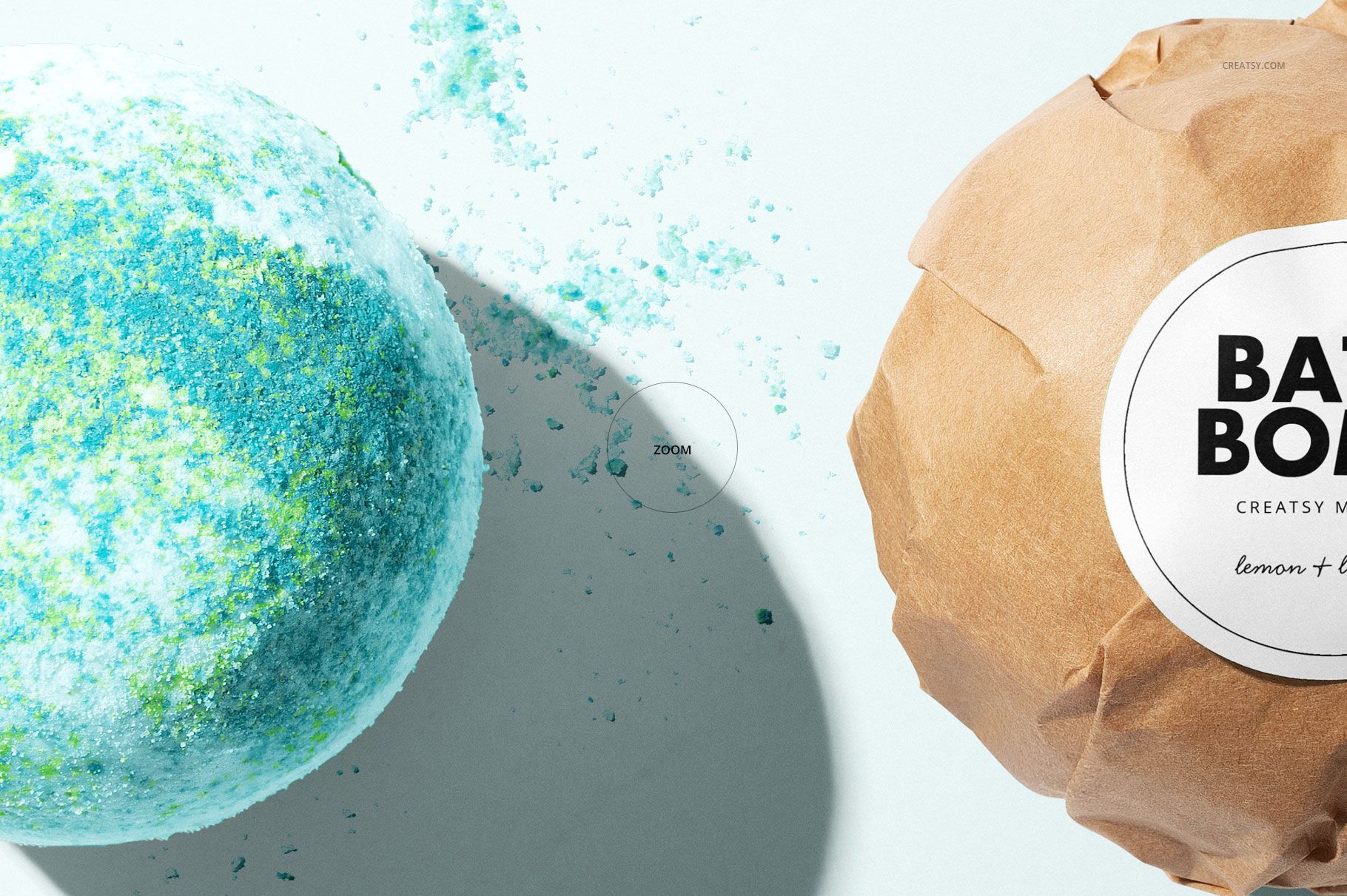 Bath bomb mockup featuring a close-up of a blue and green textured bath bomb next to a wrapped bath bomb on a light surface.