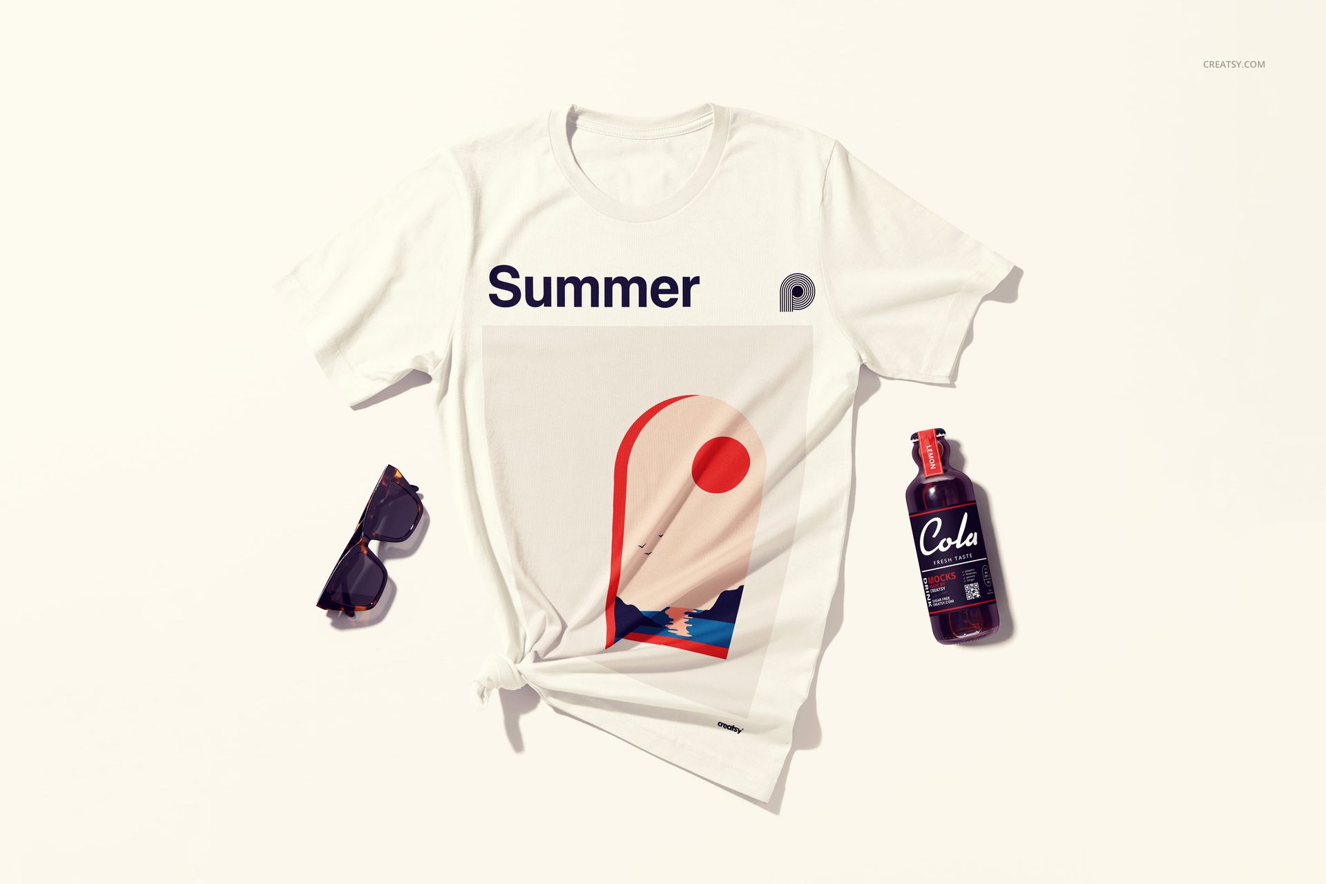 Flat lay of a white t-shirt mockup featuring a bold summer print, styled with sunglasses and a cola bottle on a light surface.
