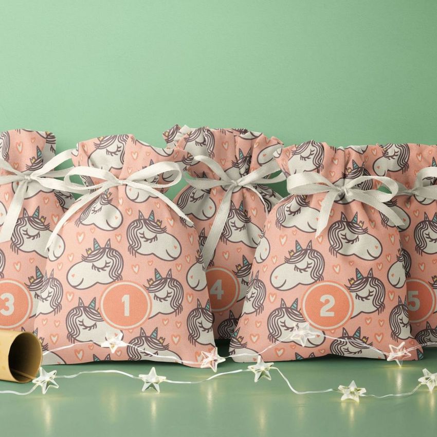 Drawstring sacks advent calendar mockup featuring pink bags with hand-drawn unicorn and heart patterns, numbered 1 to 5.