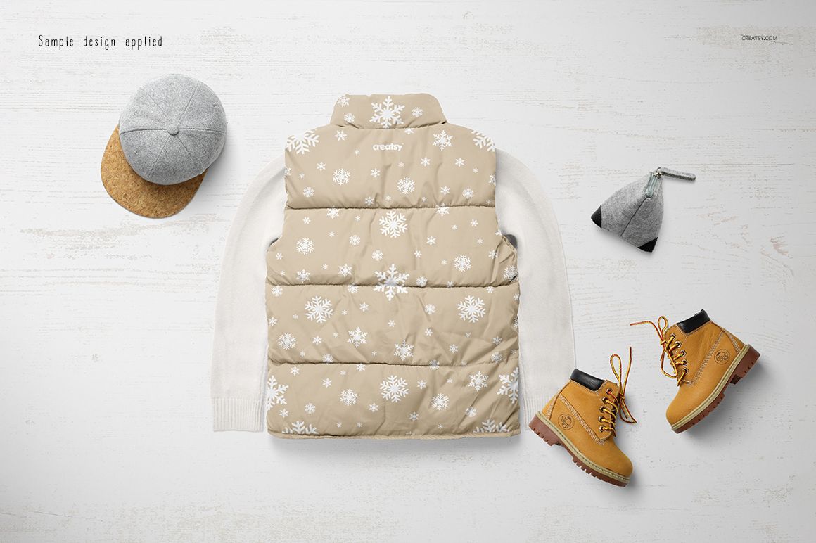 Boys winter set mockup showing a beige snowflake-patterned vest, white sweater, gray cap, and tan boots on a light surface.