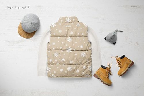 Boys winter set mockup showing a beige snowflake-patterned vest, white sweater, gray cap, and tan boots on a light surface.