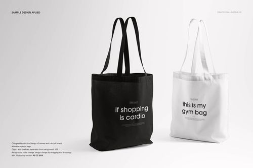 Front view of a black tote bag and a white tote bag with text designs, shown in a realistic PSD mockup setting.