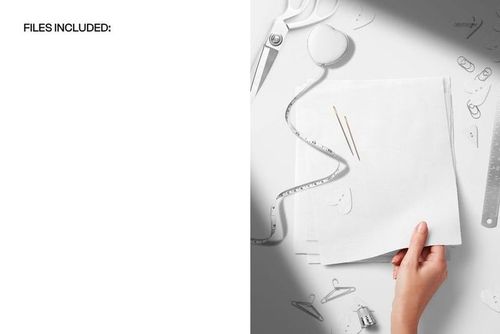 PSD mockup showing a hand with a fabric swatch surrounded by sewing accessories like ruler, tape measure, and pins.