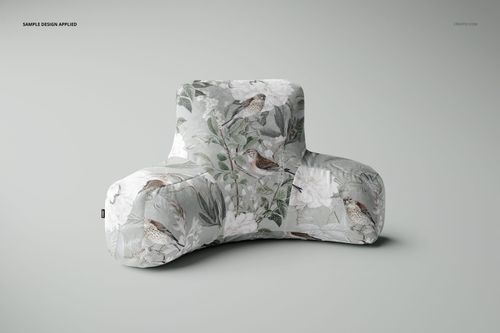 Soft reading pillow mockup featuring a nature-inspired print with birds and leaves, displayed on a plain surface.