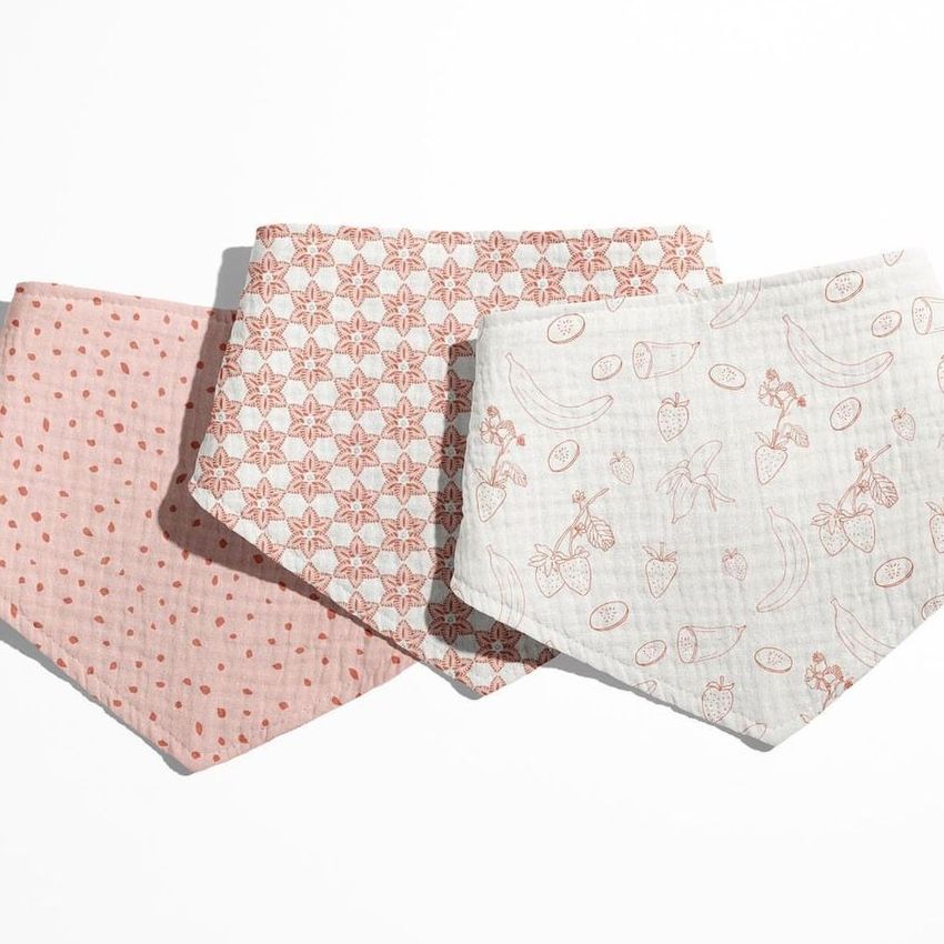 Three baby muslin bandana mockups are arranged side by side on a white background, each featuring different soft pastel patterns.