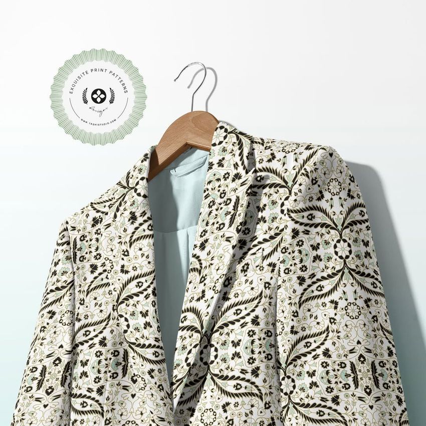 Blazer and trousers two-piece set mockup featuring a patterned suit jacket on a wooden hanger against a light wall.
