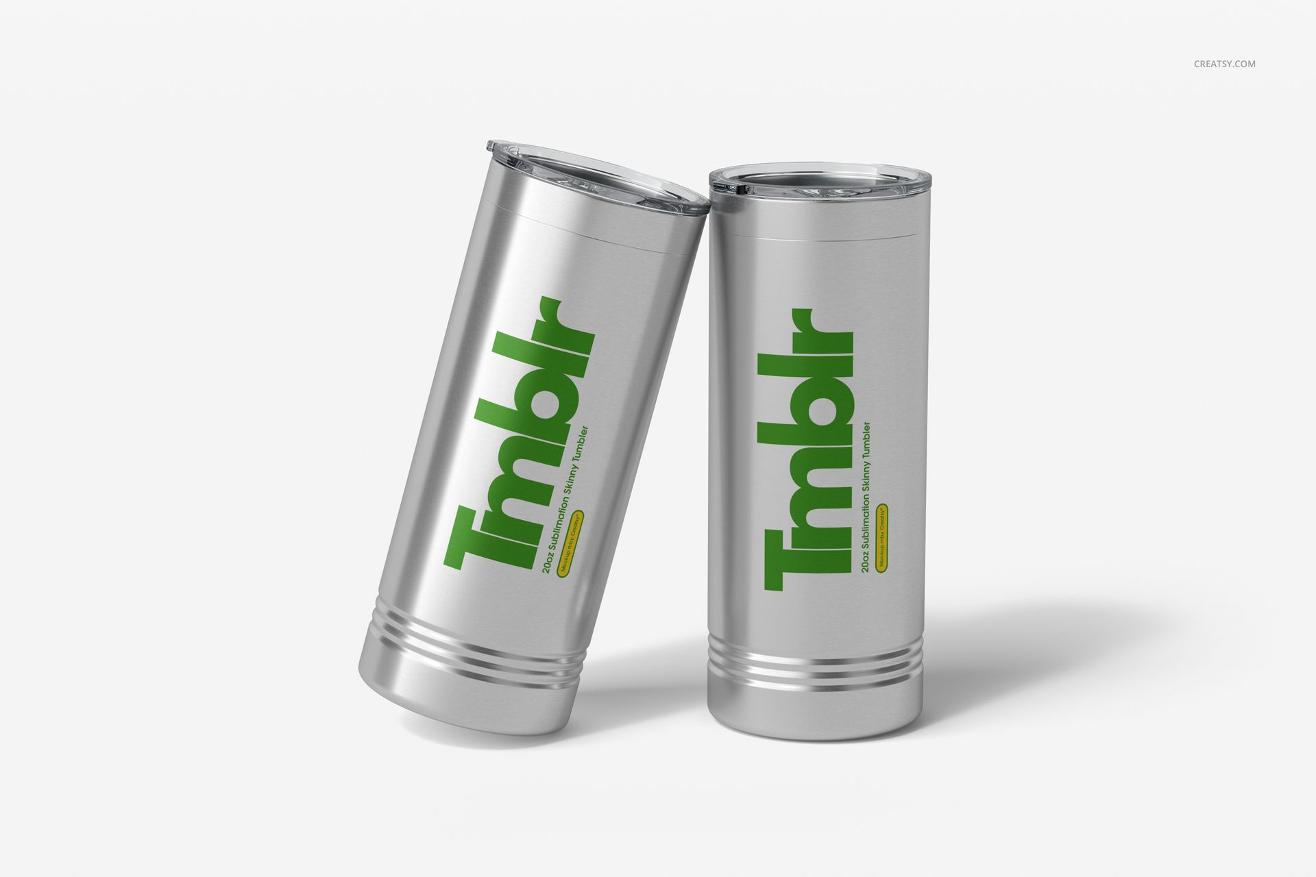 PSD mockup featuring a pair of silver skinny tumblers with green and yellow print, displayed upright on a clean surface.