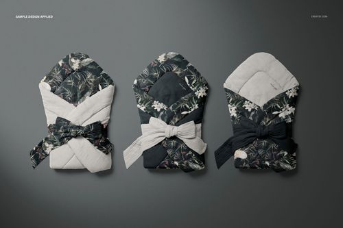Muslin baby wrap mockup set showing three wraps with botanical and plain designs, viewed from above on a gray background.