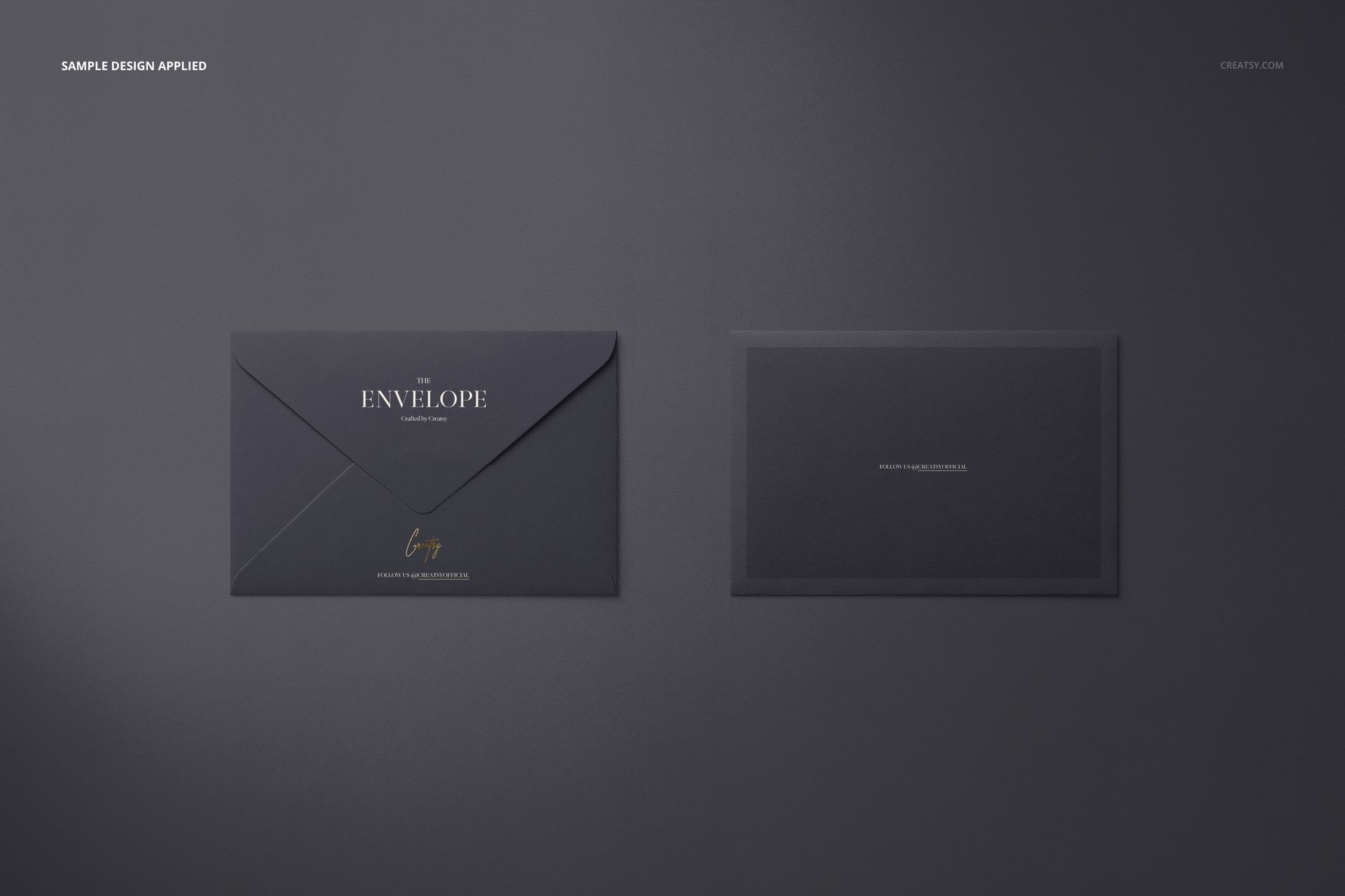 Dark gray envelope and card mockup shown from a top view, featuring simple gold and white text accents.