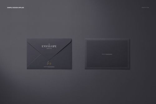 Dark gray envelope and card mockup shown from a top view, featuring simple gold and white text accents.