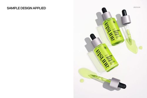 Three green dropper bottles with black caps and spilled serum displayed on a white surface in a top view mockup.