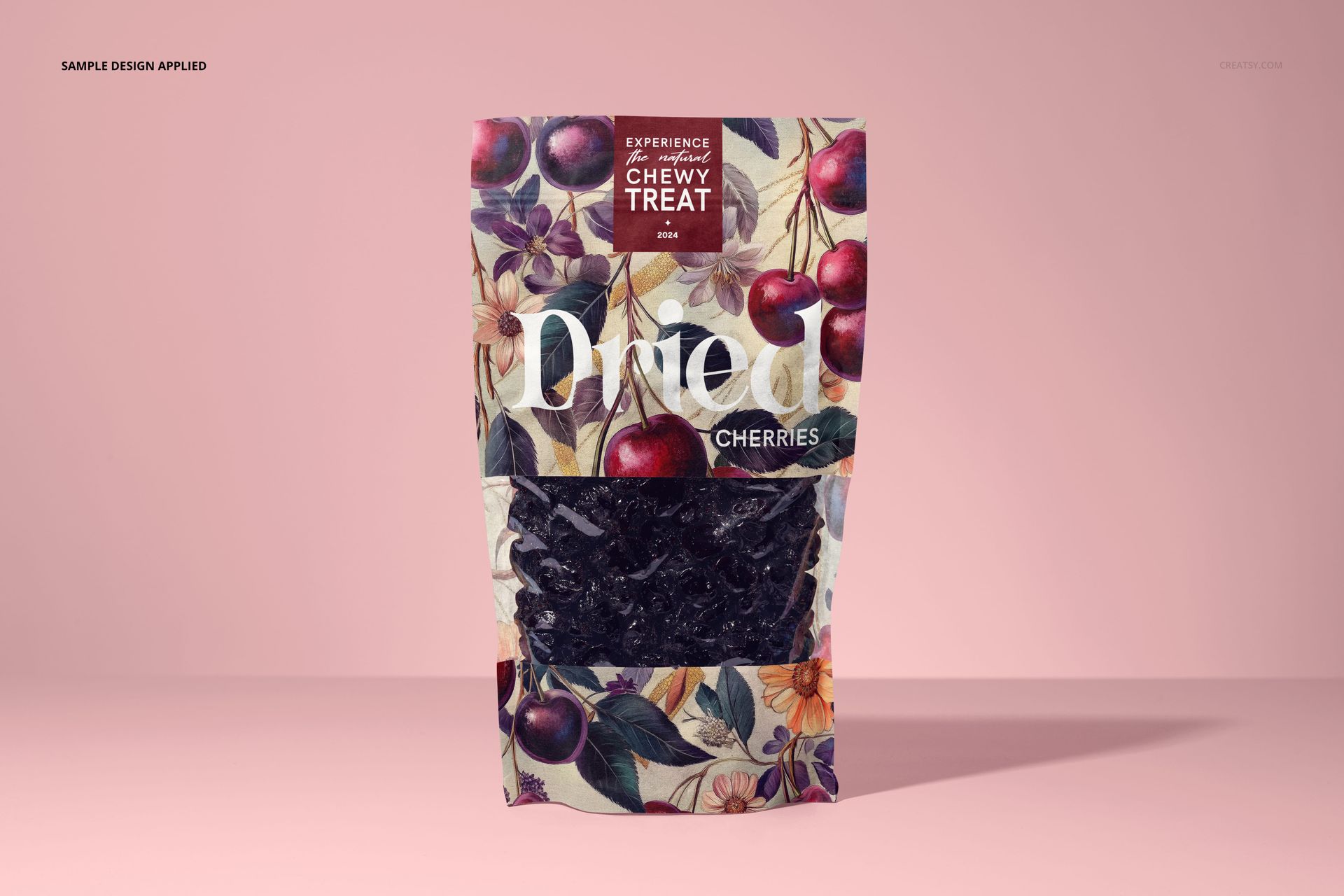 Front view of a paper pouch mockup filled with dried cherries, featuring a floral and cherry pattern on a pink background.