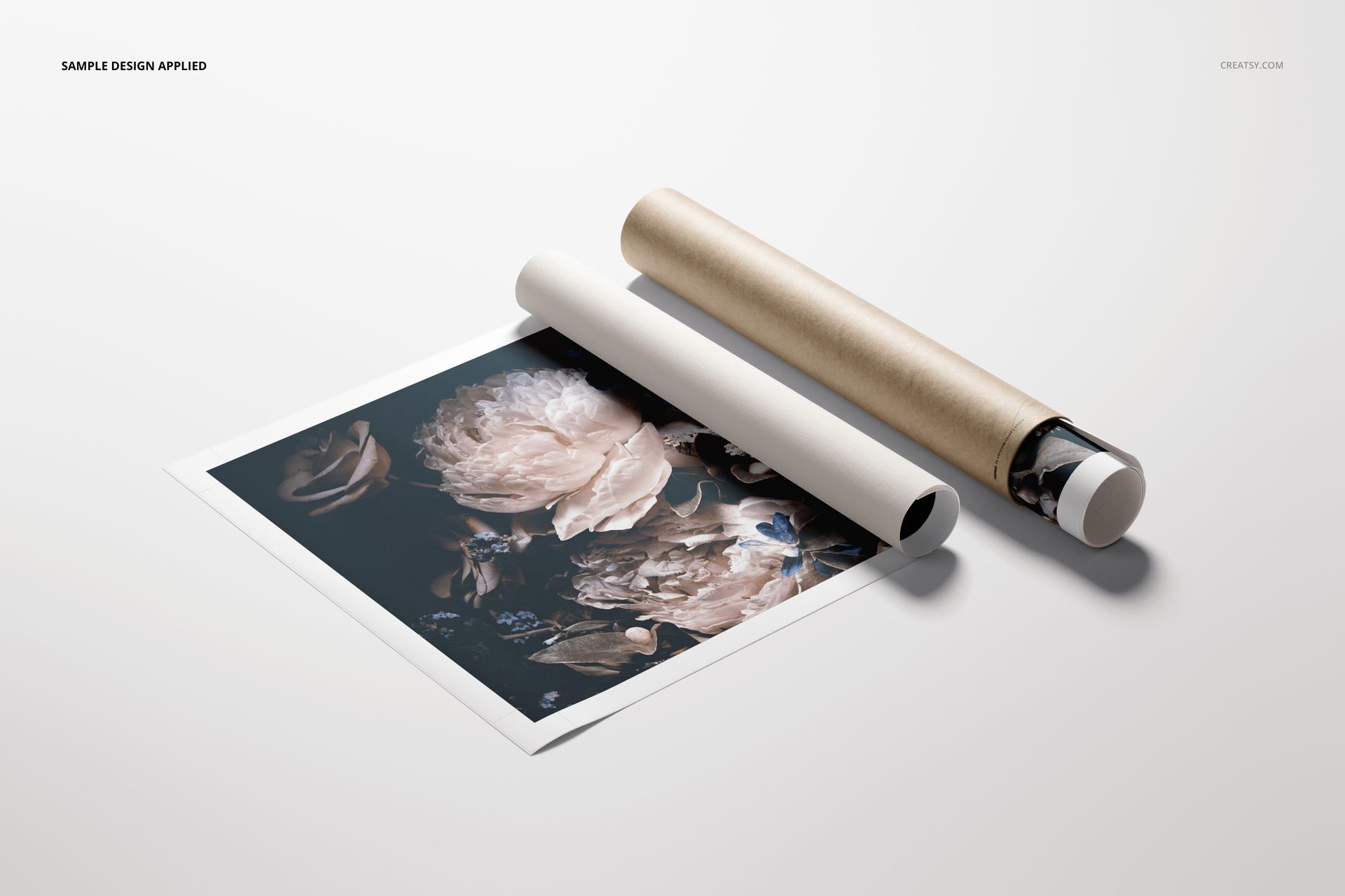 PSD mockup of a rolled canvas print featuring a dark floral design next to a cardboard tube on a neutral surface.