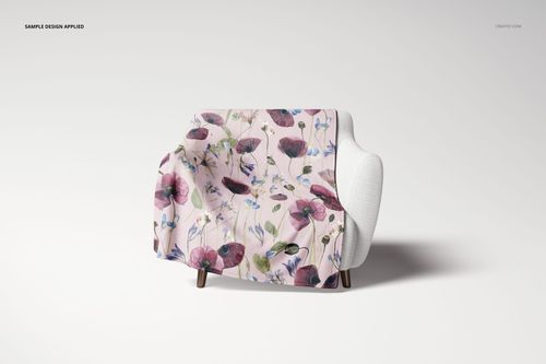 Fleece blanket mockup featuring purple and pink flowers, displayed on a modern white chair against a white backdrop.