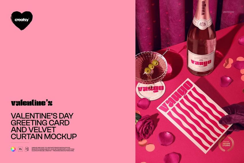 Front view of a Valentine’s Day greeting card mockup on a pink surface with velvet curtain, rose petals, and a bottle.