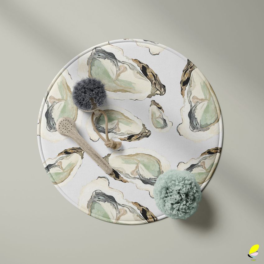 Round polyester bath mat mockup with an abstract oyster shell pattern in muted green and beige, viewed from above on a neutral background.