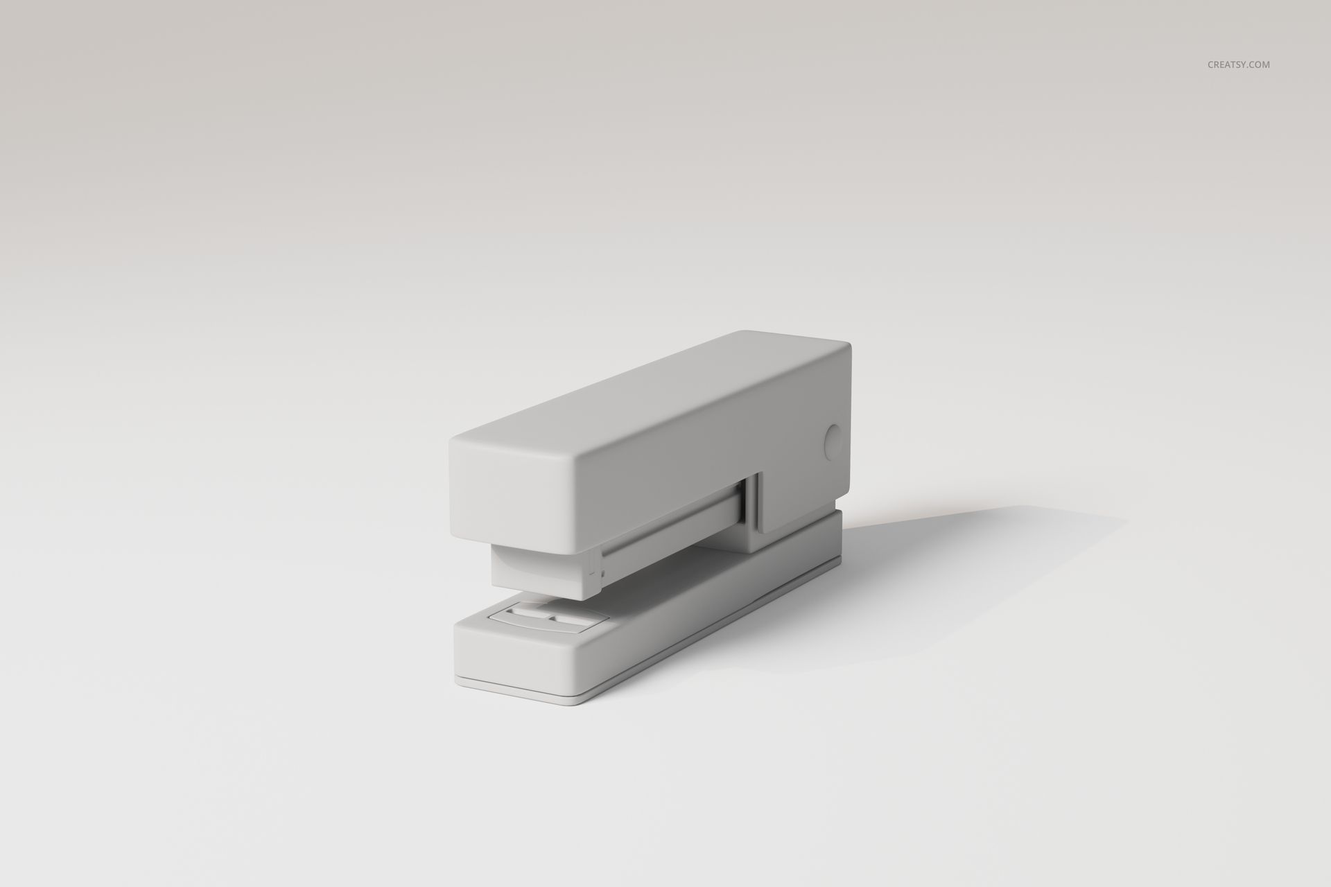 Minimalist desk stapler in light gray color, shown in a front angled view on a plain white background.