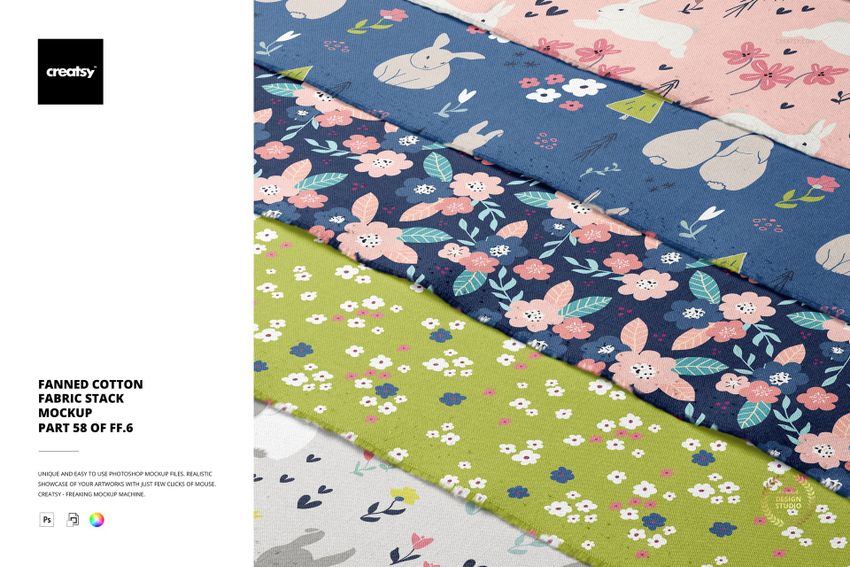 PSD mockup showing multiple folded cotton fabrics in a fan arrangement, decorated with playful floral and animal prints.