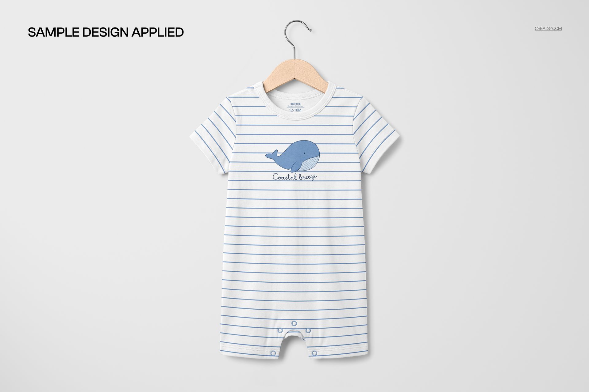 Front view of a short-sleeve baby romper suit mockup with light blue horizontal stripes and a whale graphic.