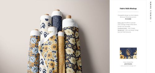 PSD mockup displaying a group of patterned fabric rolls, showcasing floral and abstract prints in blue, yellow, and white colors.