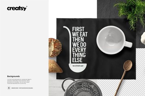 Black placemat mockup displayed from above, featuring bold white lettering, a bowl, spoon, and assorted bread.