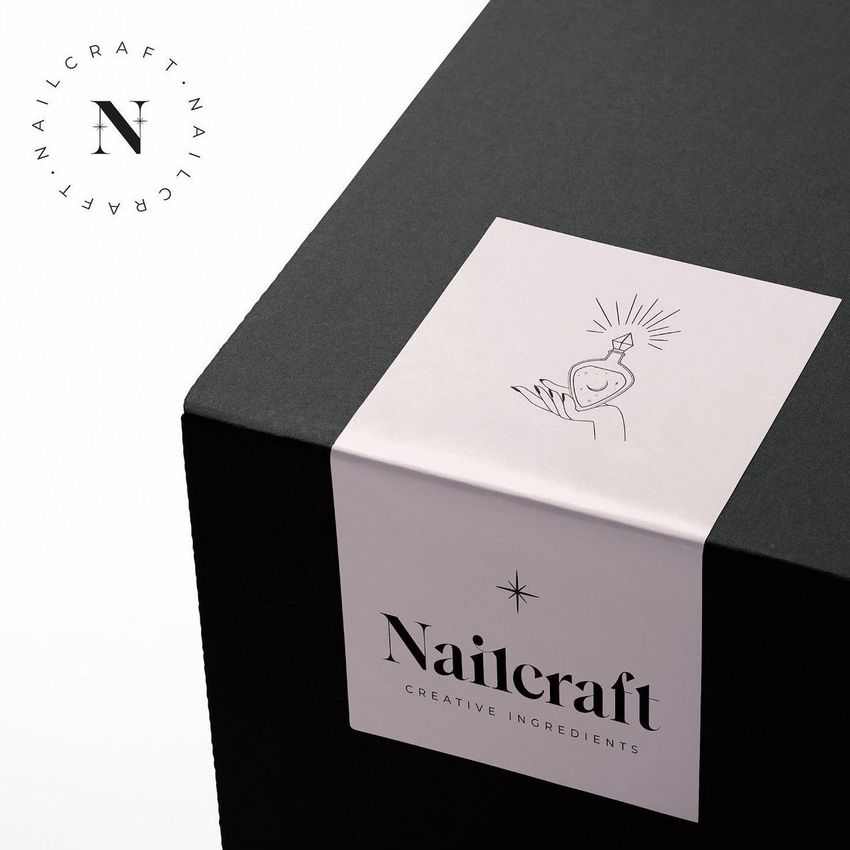 Sticker mockup featuring a white rectangular label with minimalist line art and text on a black box, shown from an angled view.