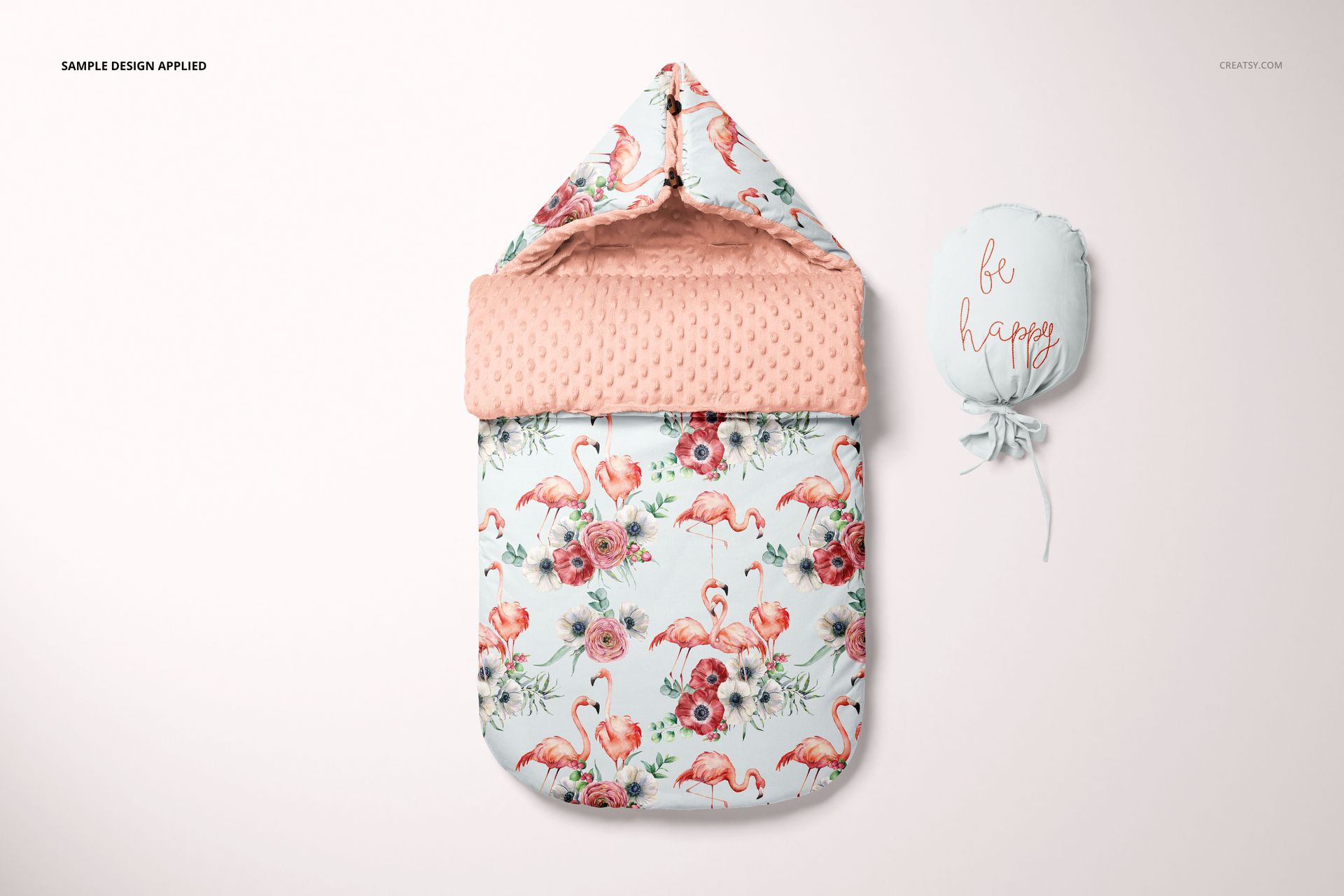 Baby sleeping bag mockup with a hood, decorated with pink flamingos and flowers, shown next to a matching pouch.