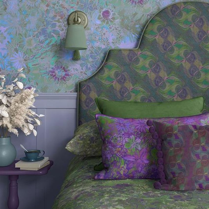 Bedroom mockup featuring a patterned headboard, floral pillows, and wallpaper in shades of green, purple, and blue.