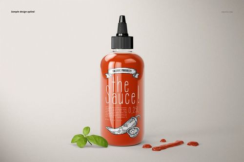 Sauce bottle mockup featuring a red bottle with black nozzle, white label, basil garnish, and spilled sauce.