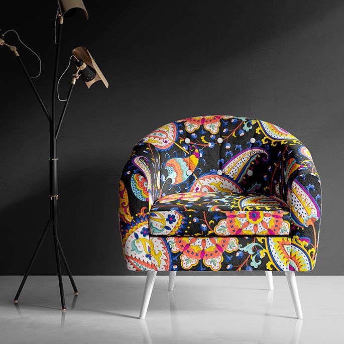 Interior scene mockup showing a patterned armchair with colorful paisley designs against a dark wall and a modern floor lamp.