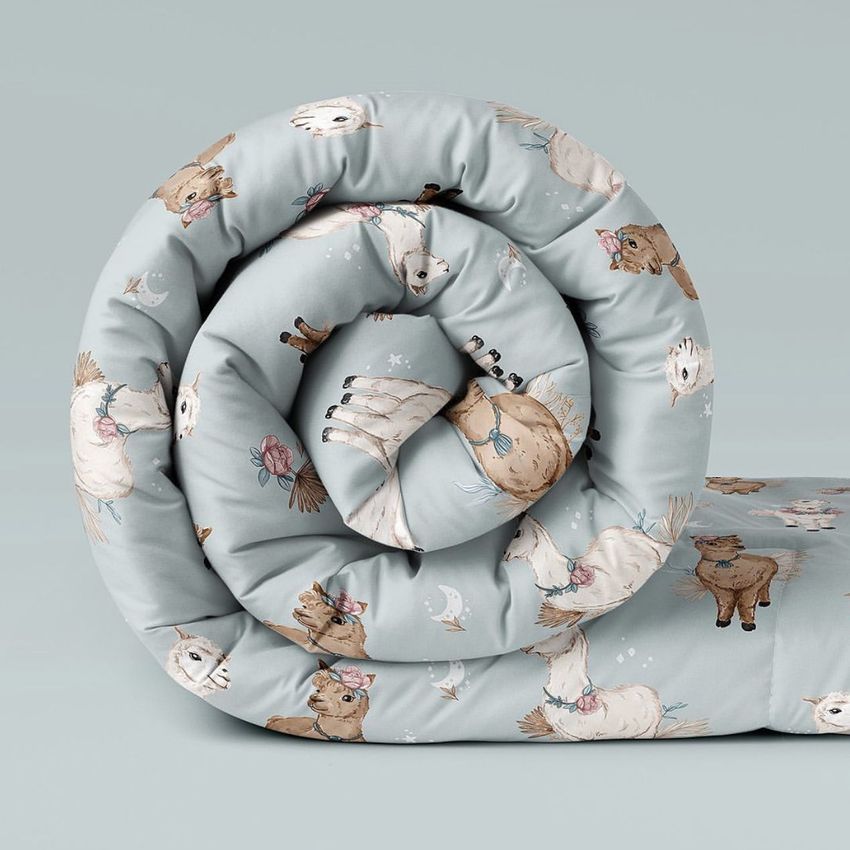 Microfiber comforter mockup featuring a rolled blanket with a light blue background and whimsical alpaca illustrations.