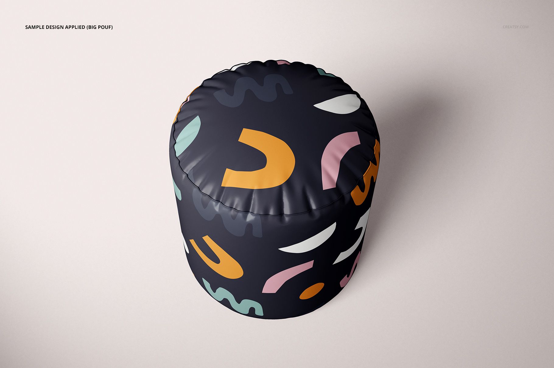Large cylindrical pouf mockup with bold, colorful abstract patterns, viewed from above on a neutral surface.