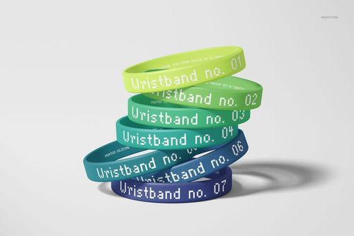 PSD mockup showing assorted green and blue silicone wristbands with numbers and text, set against a neutral backdrop.