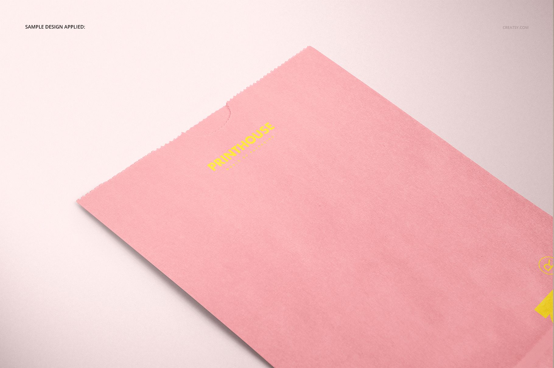 PSD mockup of a rectangular lunch bag in pastel pink, featuring yellow printed details, shown from a top angle.
