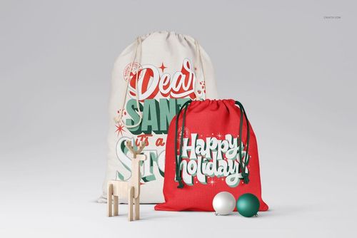 PSD mockup of Christmas Santa sacks, one cream and one red, with seasonal graphics, shown with ornaments and a wooden toy.