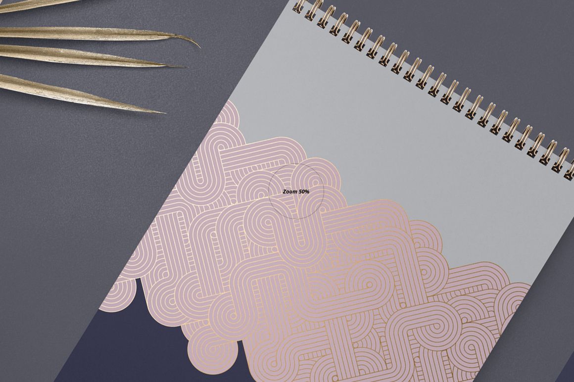 A4 vertical spiral notebook mockup with gold spiral binding, featuring geometric pink and gray patterns, top view.