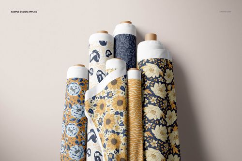Assorted fabric rolls displayed vertically, featuring blue and yellow botanical designs, shown in a PSD mockup setting.