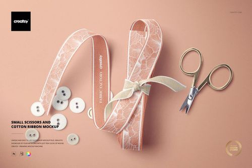 Cotton ribbon mockup featuring pink ribbon with white lace, gold scissors, and scattered buttons on a peach surface.