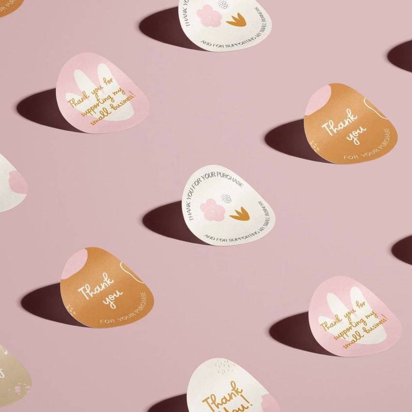 Sticker mockup featuring various pastel-colored stickers with playful patterns and thank you messages on a pink background.