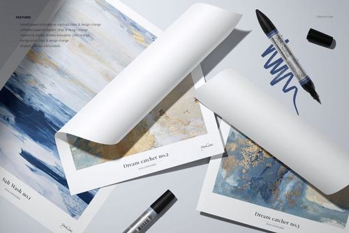 Top view of art paper mockup set featuring rolled and flat sheets with blue and gold artwork, surrounded by markers.