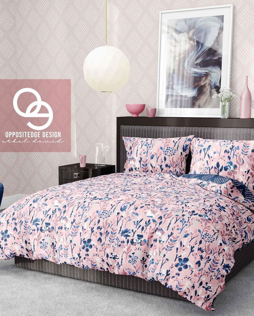 Bedding mockup set in a modern bedroom with pink and navy floral patterned duvet and pillows, gray bed frame, and abstract wall art.